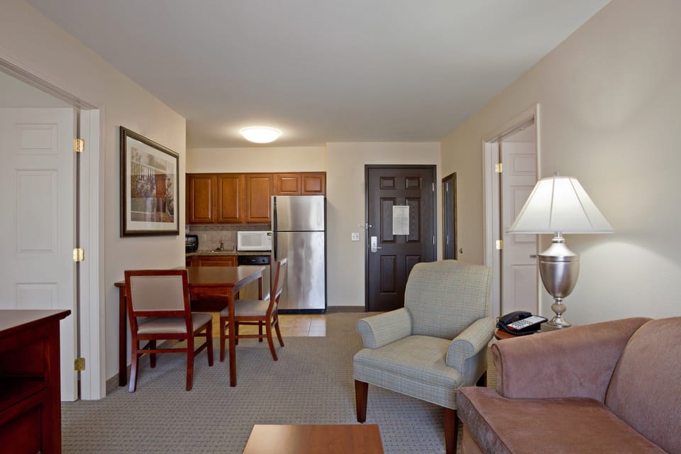 Bright living area with a dining table and fully equipped kitchenette.