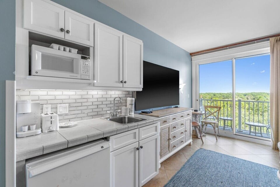 Kitchenette with coffee maker, toaster, mini fridge and microwave