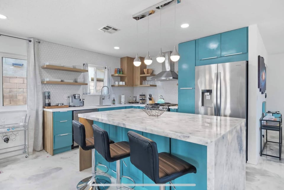 Kitchen island with seating for 3 and quartzite counter that light up.