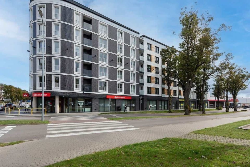 An exterior view of the apartment building, showcasing its contemporary architecture and surroundings.
