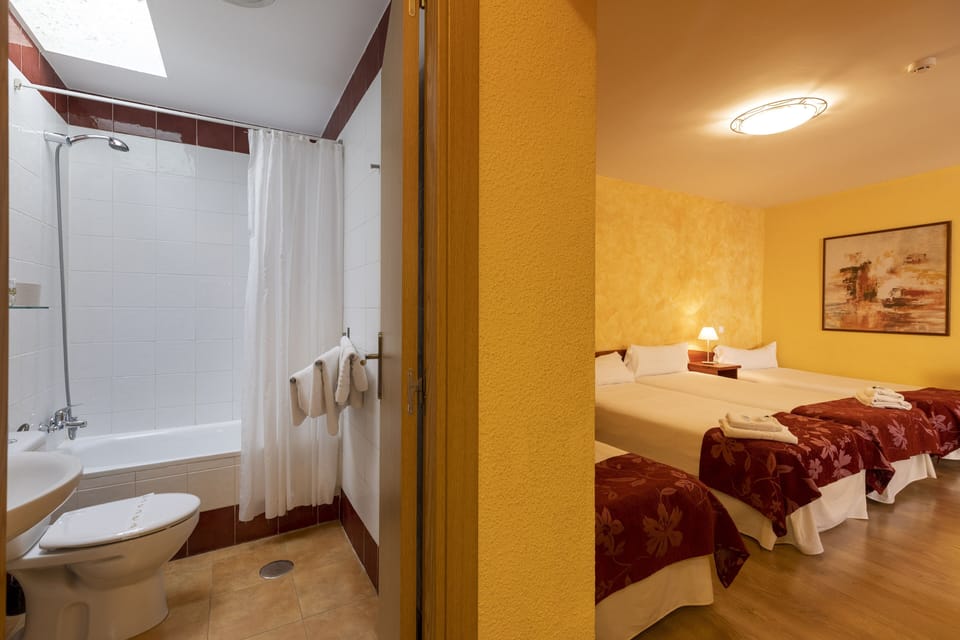Quadruple Room | Down comforters, blackout drapes, free WiFi, bed sheets