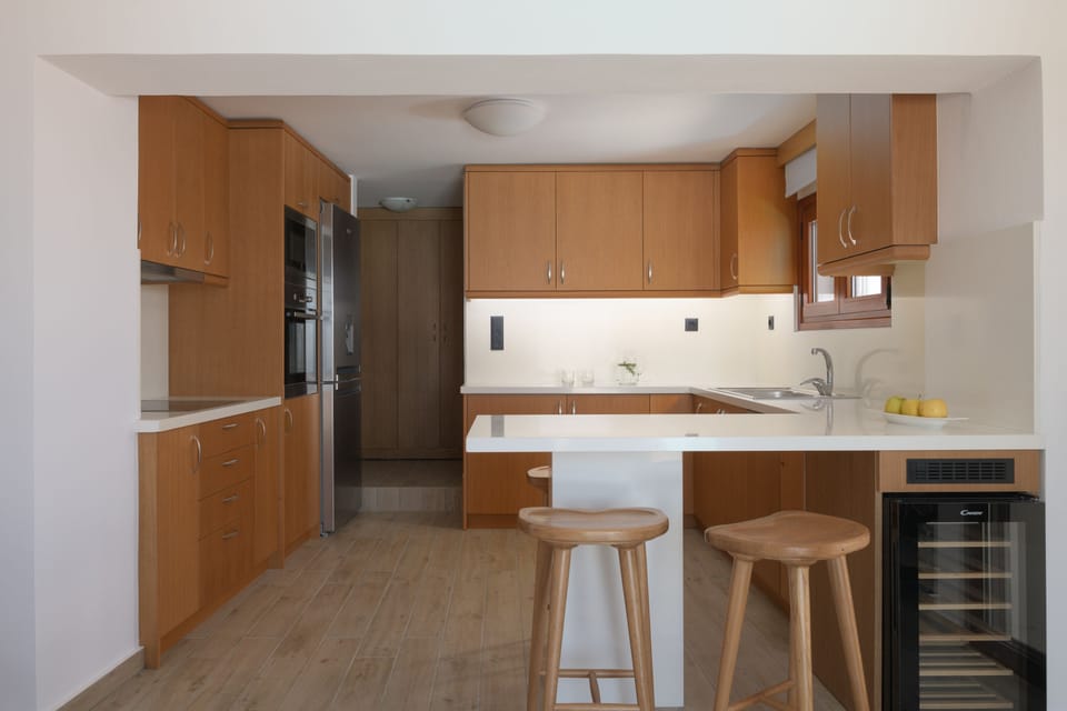 The fully equipped kitchen features also a wine fridge.