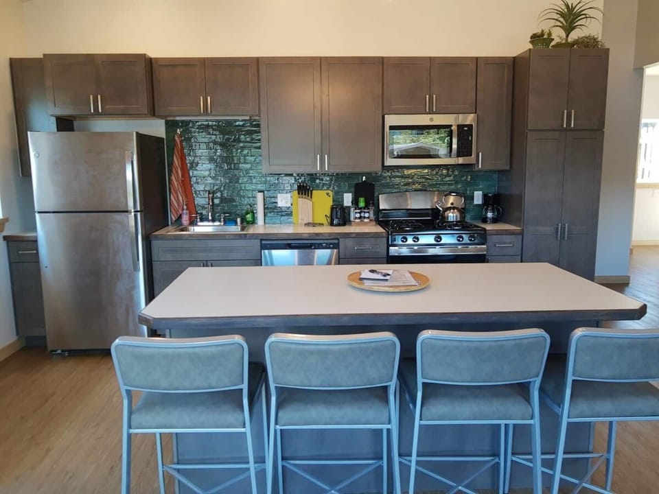 Alderwood Cabin Kitchen - Equipped with Residential Fridge, 12-Cup Drip Coffee Maker, Toaster, Microwave, 4-burner stove with Oven, Tea Kettle, Coffee, Creamer, Sugar, Tea, Filters, and Basic Cooking Essentials.