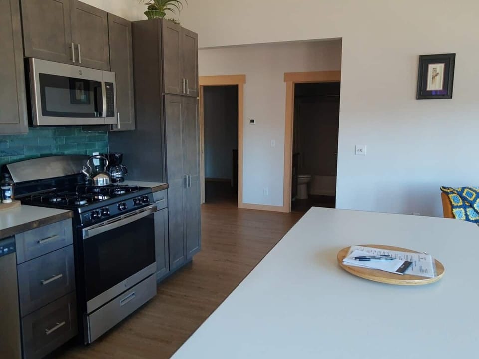 Alderwood Cabin Kitchen with view of Laundry room and Central Bathroom