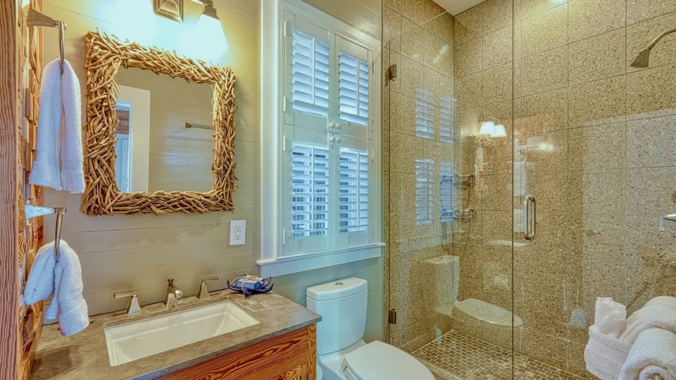 The second suite includes an en-suite bathroom with a walk-in shower...