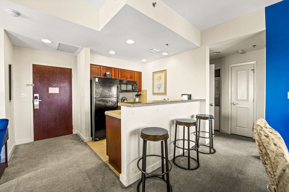 3 counter height seats and Kitchen area