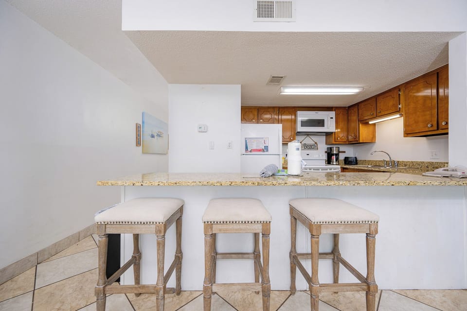 Gather around the inviting counter stools and enjoy a casual morning coffee while soaking in the coastal vibe
