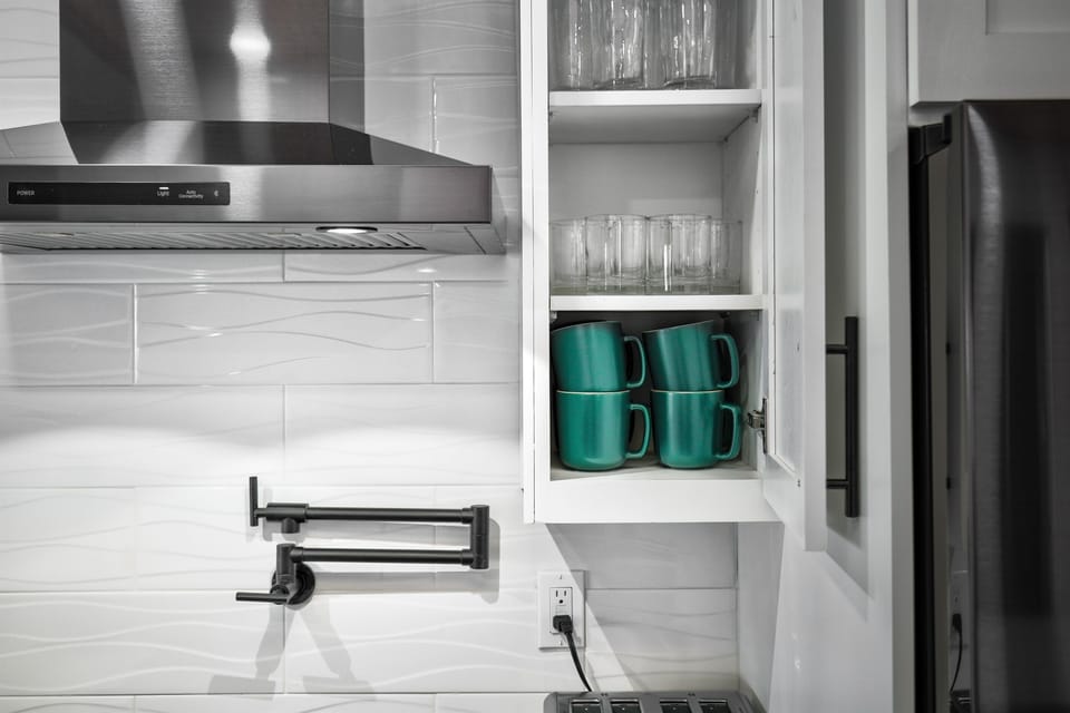 Well stocked kitchen with mugs, glasses, and essentials