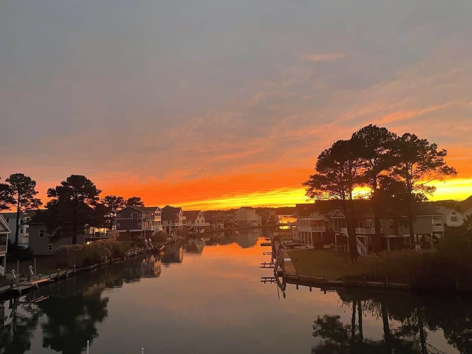 Watch the sky light up with a fiery sunset over the canal.