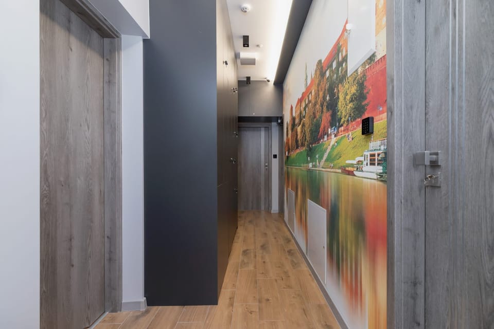 A hallway with artistic wall decor, leading to the living spaces with a bright and welcoming ambiance.
