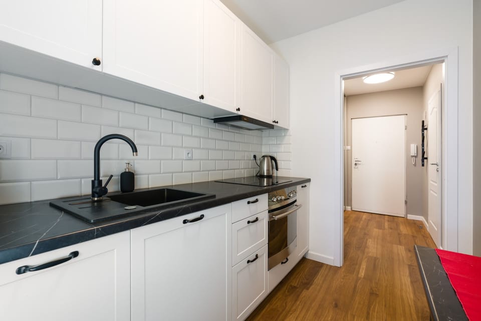 A sleek and functional kitchen with a minimalist design and elegant finishes.
