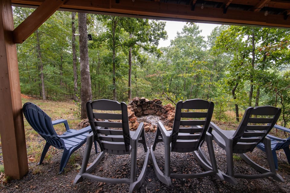- Outdoor firepit seating with relaxing forest backdrop   - Rocking chairs create a calm place to unwind   - Ideal spot for evenings under the trees and stars