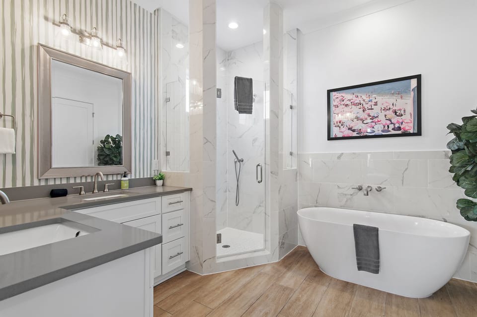 Spacious ensuite with walk-in shower, soaking tub, and double vanities.
