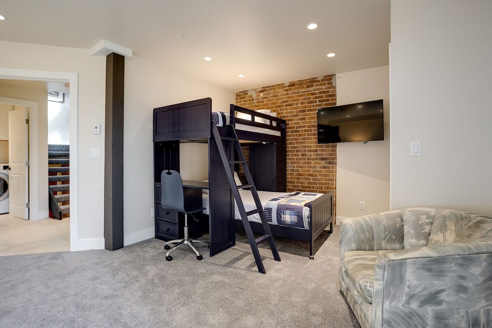Your kids will love this cozy bunk bed setup with its own workspace, while you enjoy the open living area.