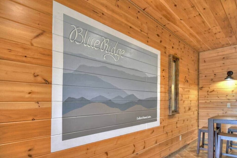 A beautiful wall painting of the mountains in the game room to take a picture in front of