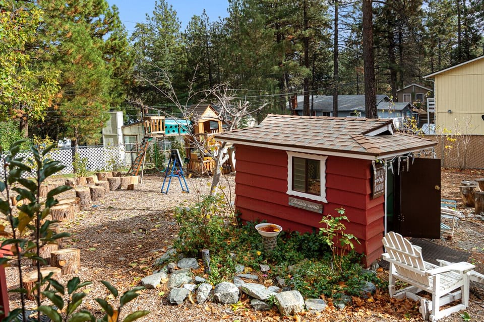 Spacious backyard with a swing set and playhouse, perfect for kids to play and explore.