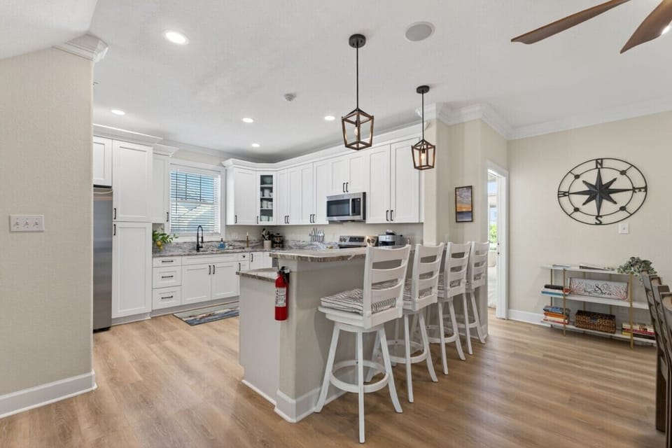 Gather around the oversized island with seating for the whole crew, perfect for meals, snacks, and conversation.