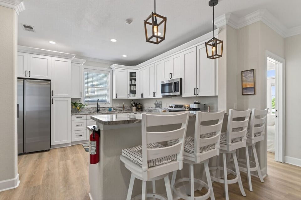 Fully equipped gourmet kitchen with a large island and seating for six.