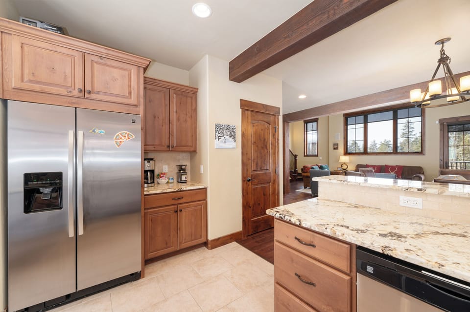 Your gourmet kitchen features granite countertops, stainless appliances, and rustic wood beams creating the perfect cooking retreat.