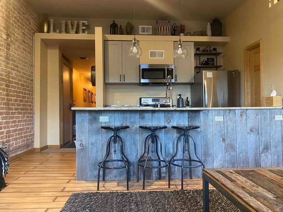 Enjoy the open living room and kitchen with 3 beautiful windows looking over F street. (2)