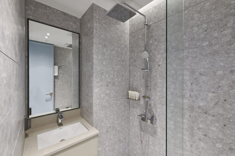 Twin Room (No Parking) | Bathroom | Shower, hair dryer, bathrobes, slippers