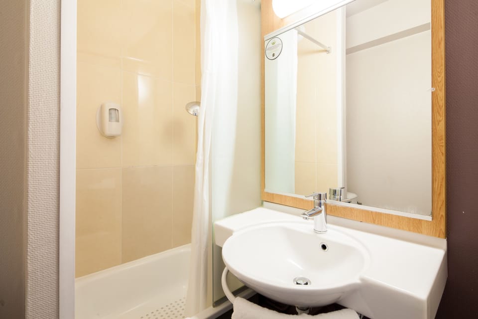 Shower, rainfall showerhead, hair dryer, towels