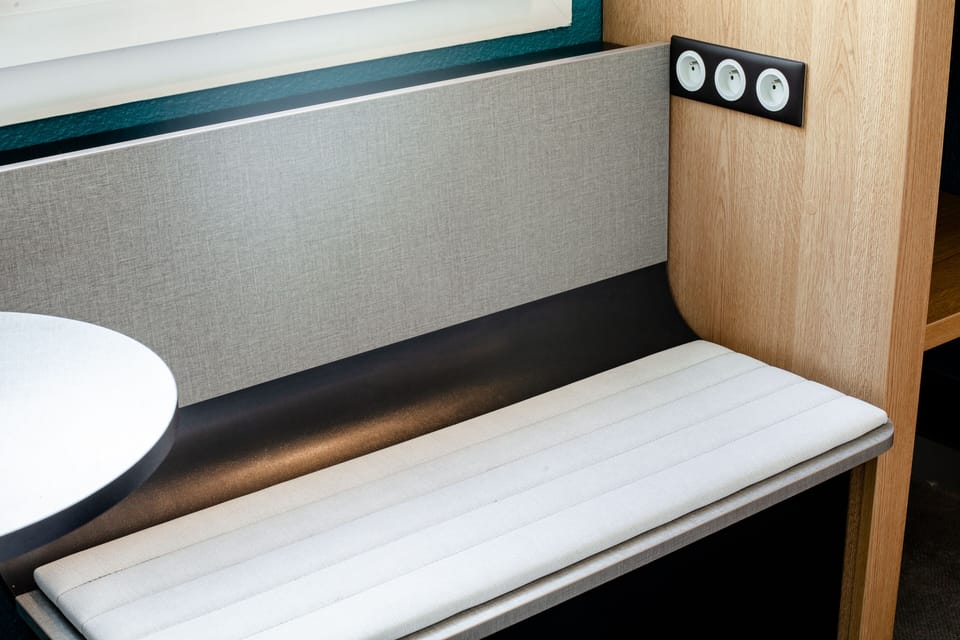 Premium bedding, laptop workspace, blackout drapes, soundproofing