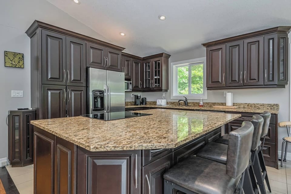 The large kitchen island with bar stools provides a great place to entertain. 