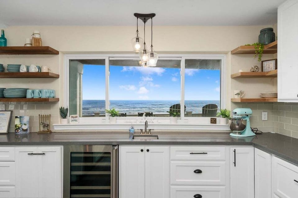 Kitchen with ocean-view window, wine fridge, and ample counter space