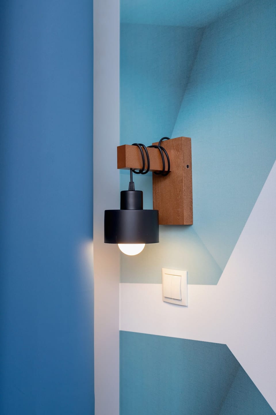A close-up of decorative ceiling lighting with geometric shapes, adding a stylish touch to the interior.

