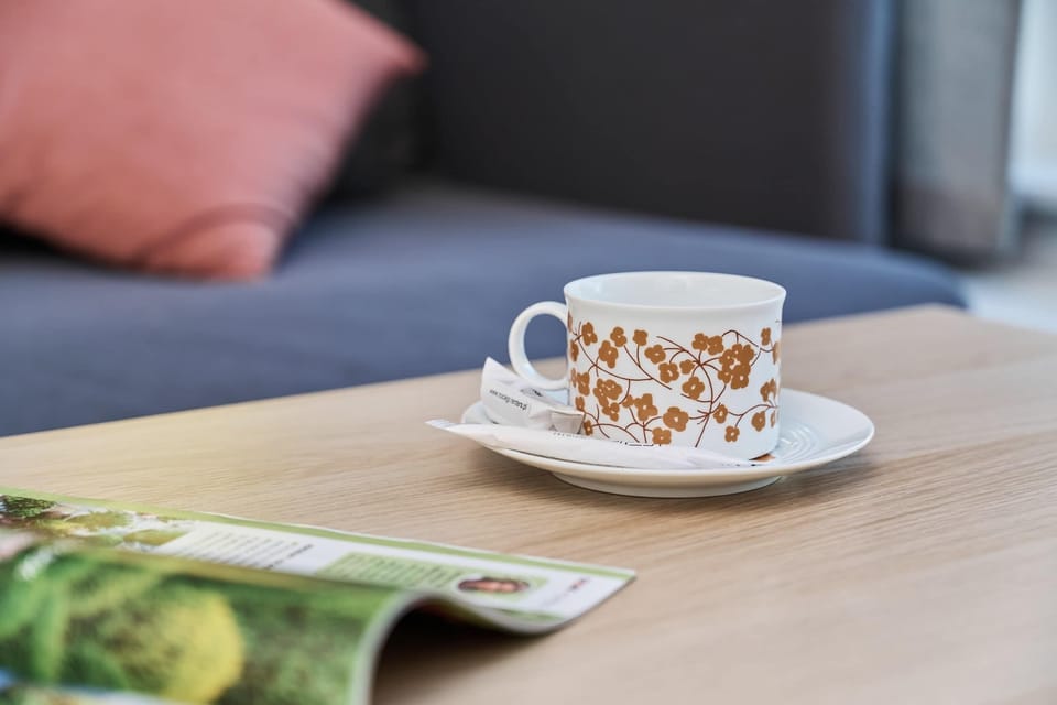 A cozy coffee corner with a cup and book, offering a relaxing spot for unwinding.
