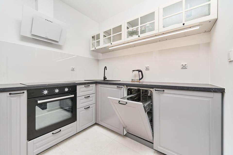 A fully equipped kitchen with ample storage, sleek countertops, and modern appliances.

