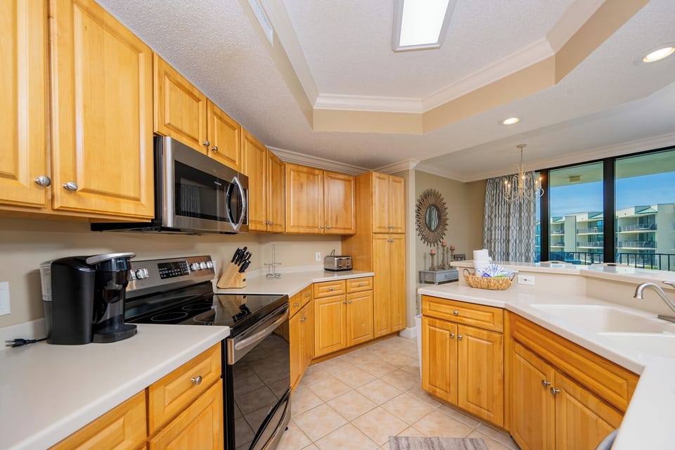 Prepare meals in this kitchen with elegant cabinetry, stainless appliances, and spacious countertops