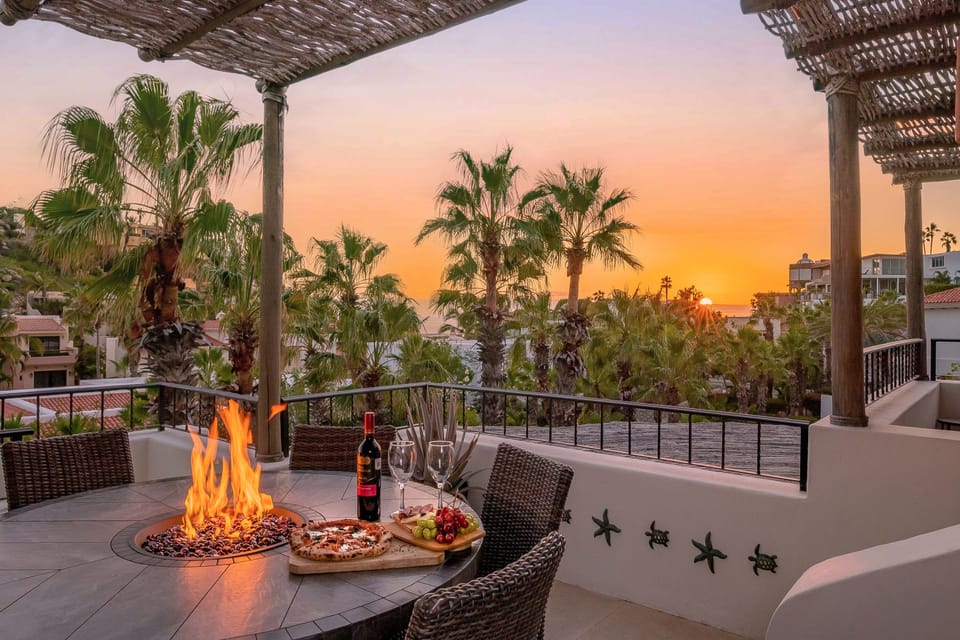 Outdoor dining with firepit over looking a gorgeous sunset view