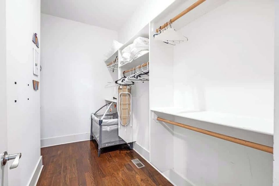 Spacious walk-in closet with hangers, linens & pack ’n play