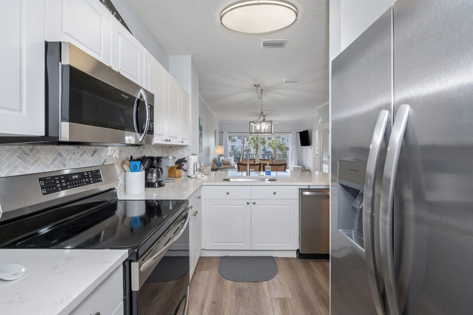 Kitchen with updated stainless steel appliances.