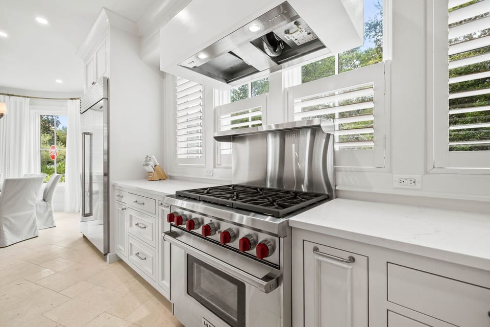 Gourmet Chef's Kitchen with Professional-Grade Appliances, Oversized Island, and Sunlit Dining Nook