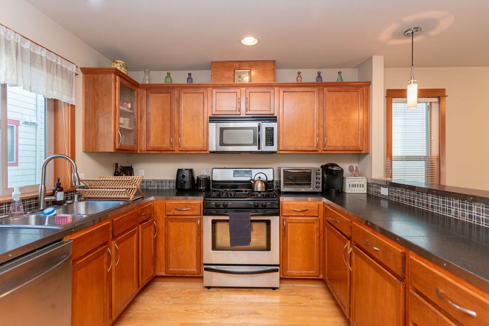Countertop has air fryer, toaster, tea kettle, toaster oven, Keurig coffee maker