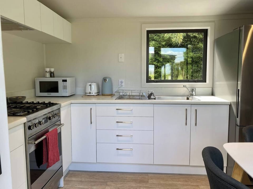 the kitchen pod. This is a full working kitchen with large fridge/freezer, food cupboards and all pots/pans/cuttlery etc supplied. The living pod also has mini fridge,toaster/kettle/mugs etc so you dont have to go to the kitchen at night for a cuppa