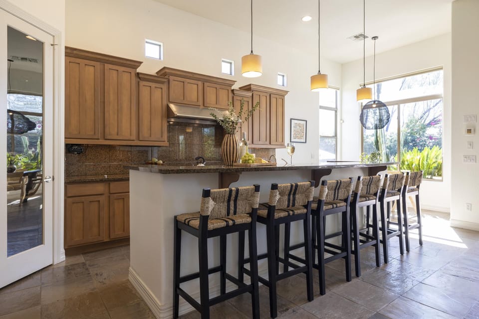 Spacious kitchen features tons of barstool seating at the island counter.
