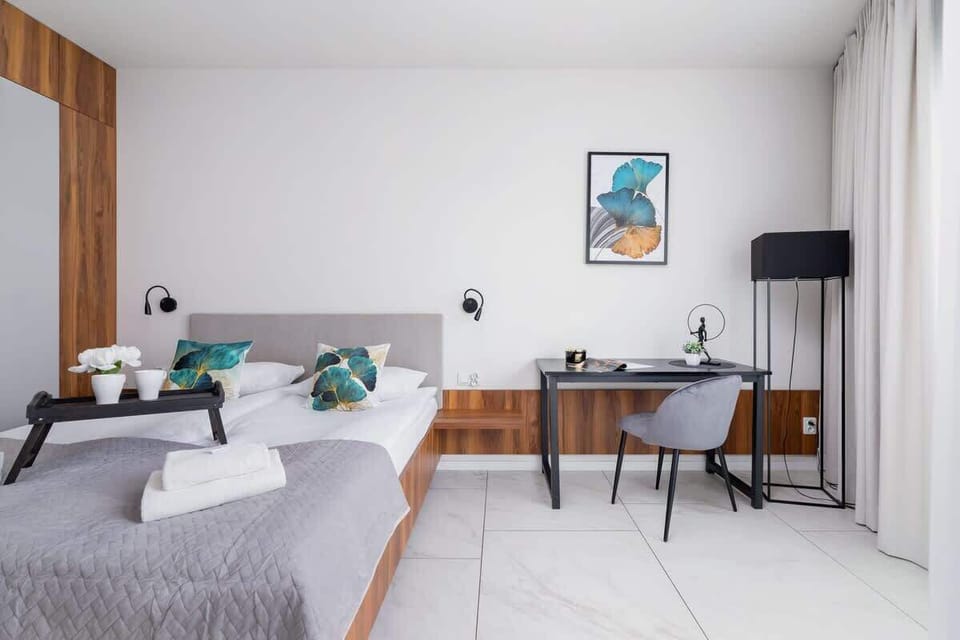A bright corner with a large window and a desk setup, perfect for work or relaxation.
