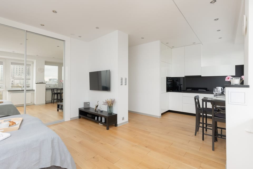 A wide view of the combined living and kitchen space, highlighting its cohesive and functional layout.
