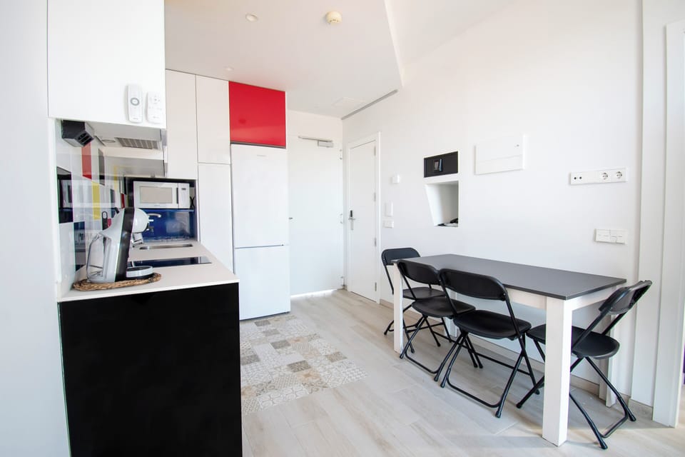 Deluxe Duplex | Private kitchen | Coffee/tea maker, highchair, dining tables