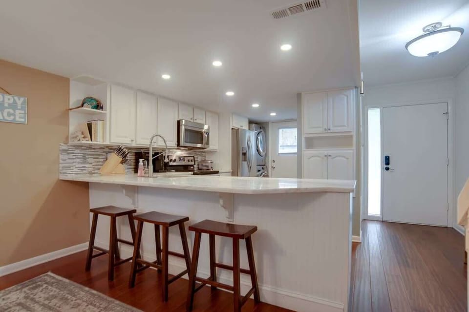 Gather around this bright kitchen island with three bar stools, perfect for morning coffee or casual meals together.