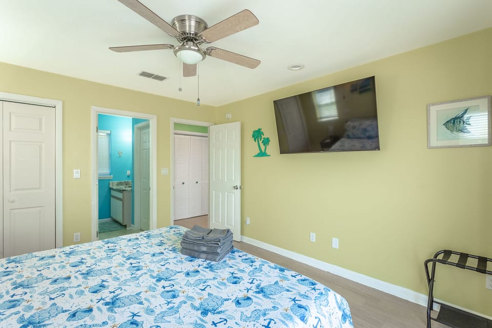 The main bedroom with an en-suite bathroom and a TV for enhanced relaxation.