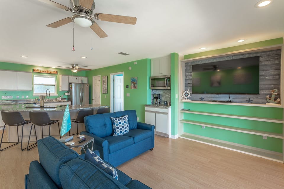 65" Roku Smart Tv with Streaming options and a spacious open concept living area