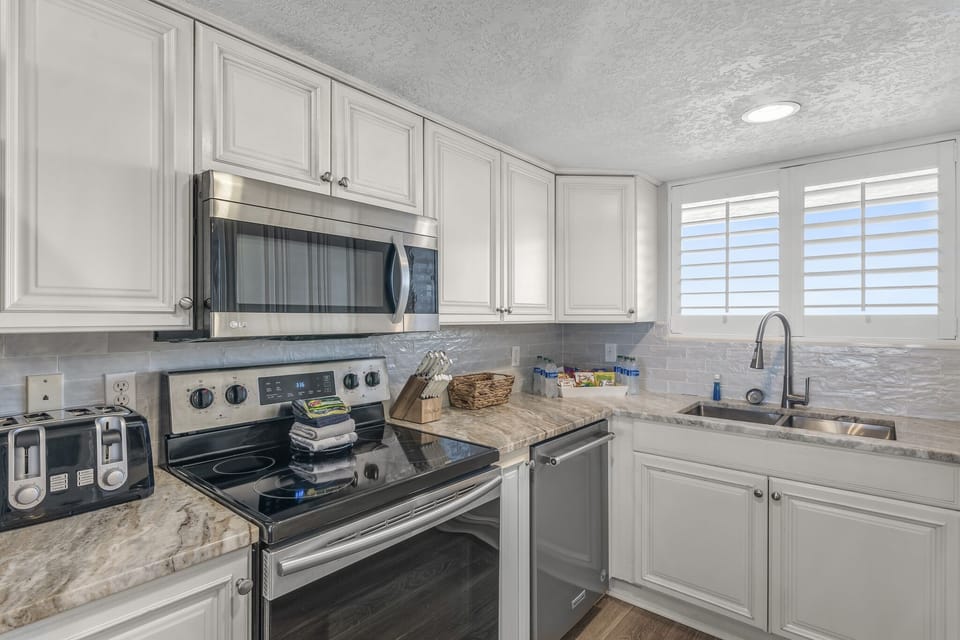 Remodeled kitchen has new countertops, stainless appliances, and is fully stocked so you can prepare meals in your home away from home!