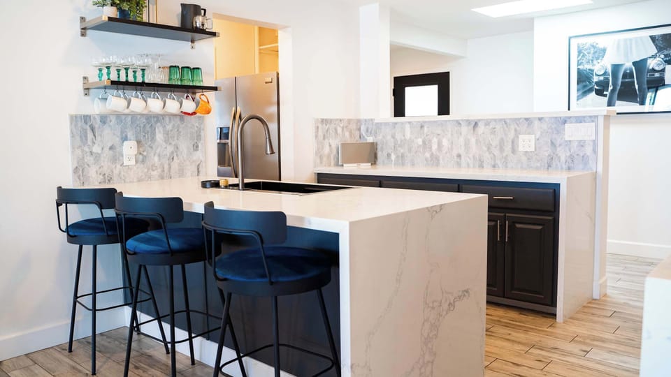 Kitchen bar/island with large barstools 