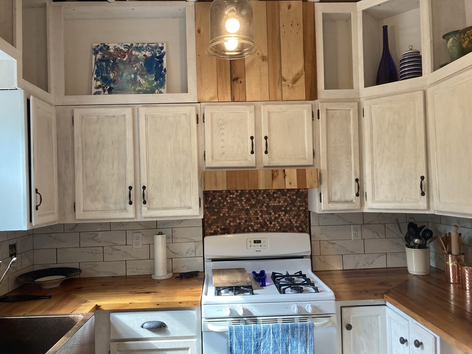 Custom kitchen with copper farm house sink and reclaimed counter tops