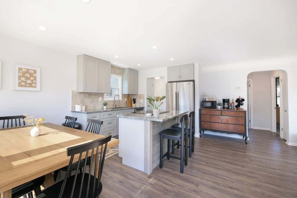 Open kitchen & dining area w/ island seating & seamless flow